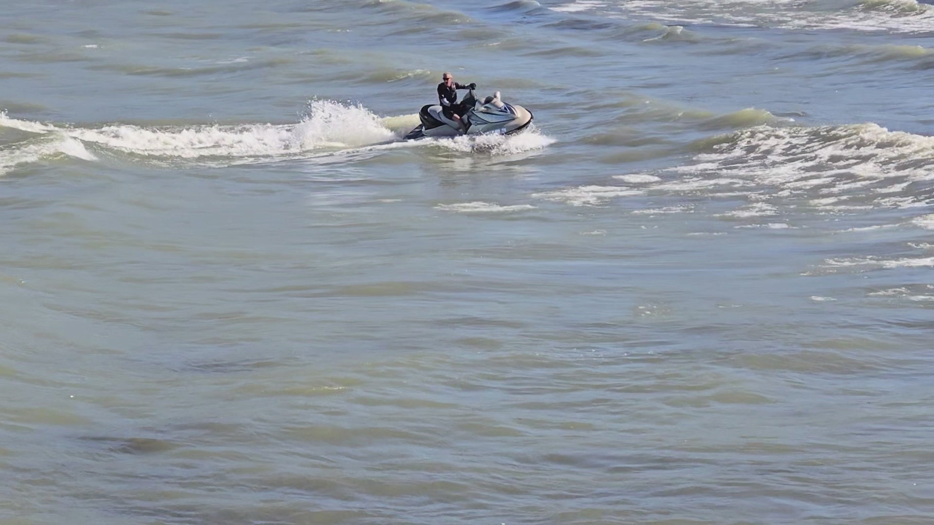 Load video: Man riding jetski in Lake Erie.